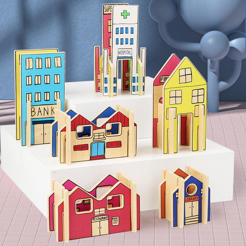 Set of colorful wooden toy buildings on a white surface with a blue background