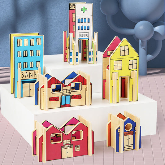 Set of colorful wooden toy buildings on a white surface with a blue background